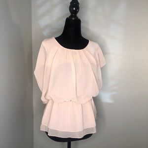 Sheer pink women’s armless blouse.